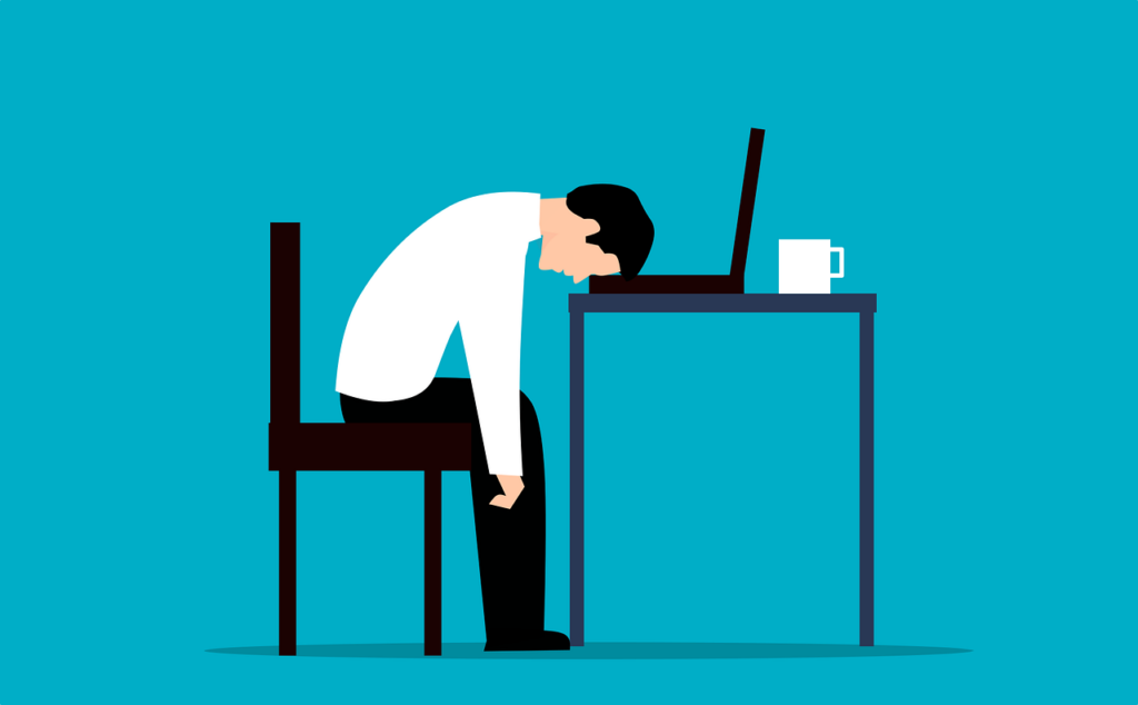 cartoon of man with his head on a desk in Portland OR