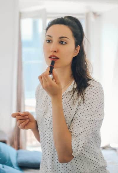 remote worker in Portland OR applying makeup