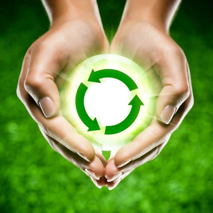 Hands holding a recycling symbol
