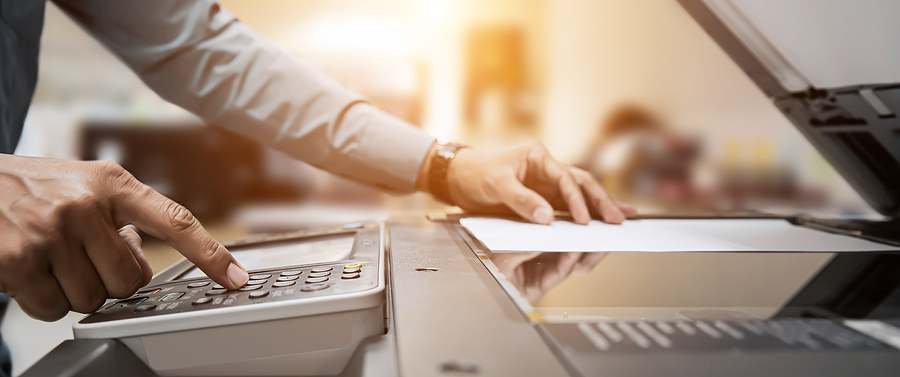 DataSafe offers document scanning services in Portland, OR to help clients like this person scanning a document.