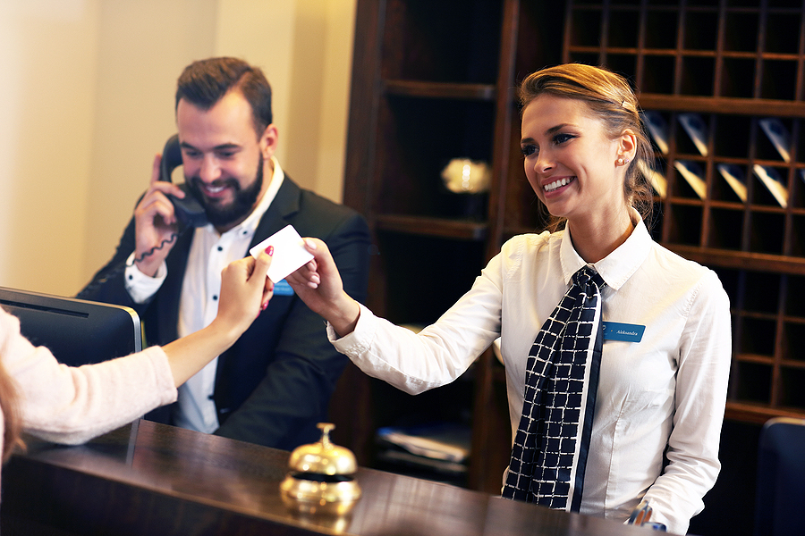 guests getting key card in hotel.  DataSafe provides shredding services for hotels